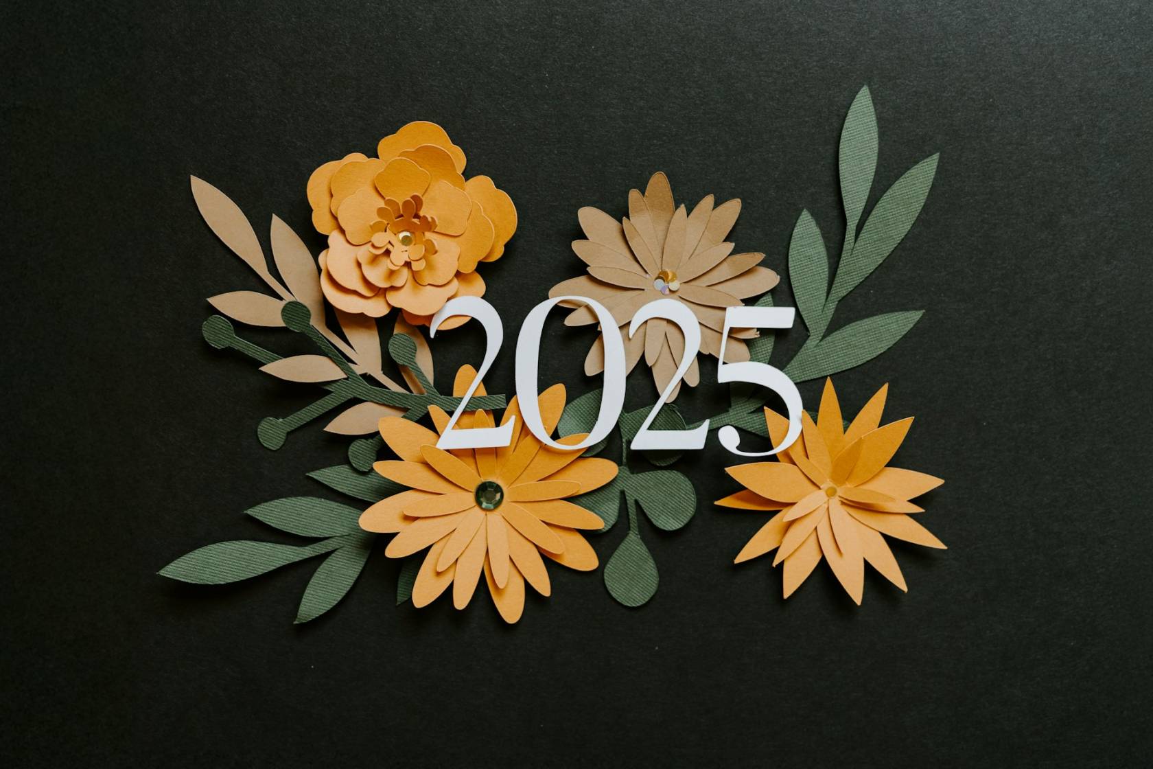 Flower petals arranged on paper with creative arts design and "2025" text in floral style.